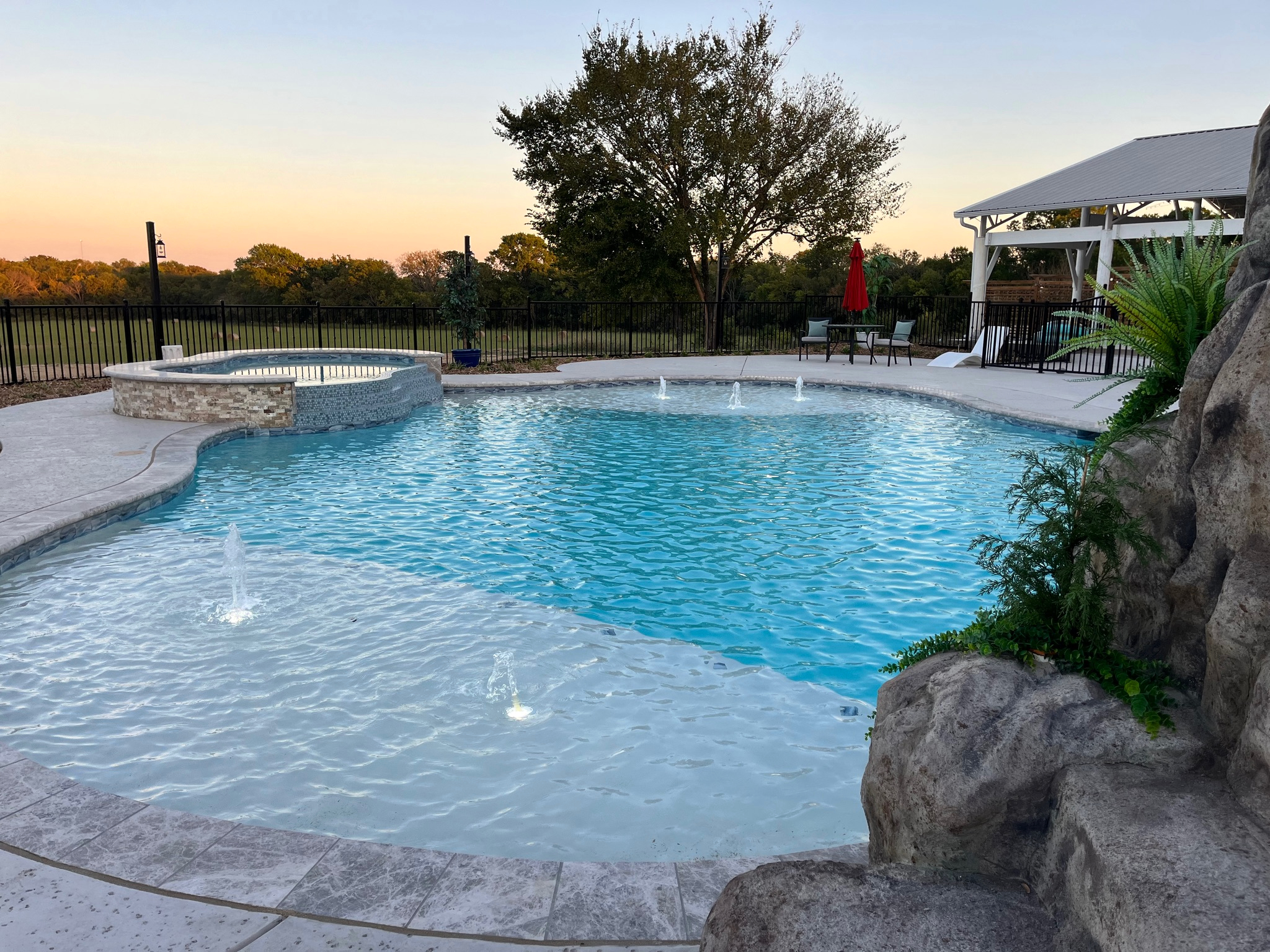 Resort style 30,000-gallon saltwater pool with double waterfalls and grotto and slide