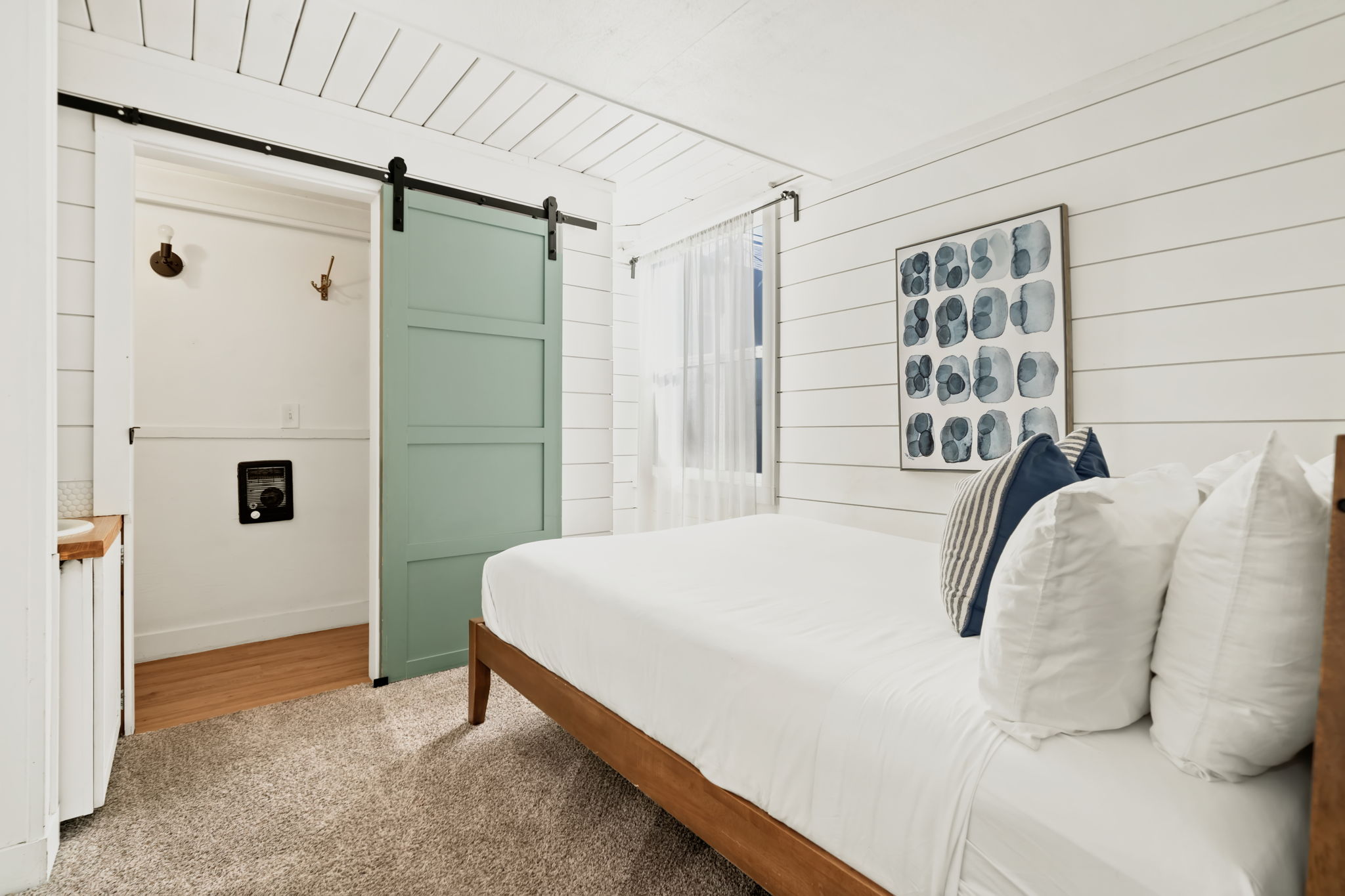 Main floor level bedroom with private bathroom and Queen bed