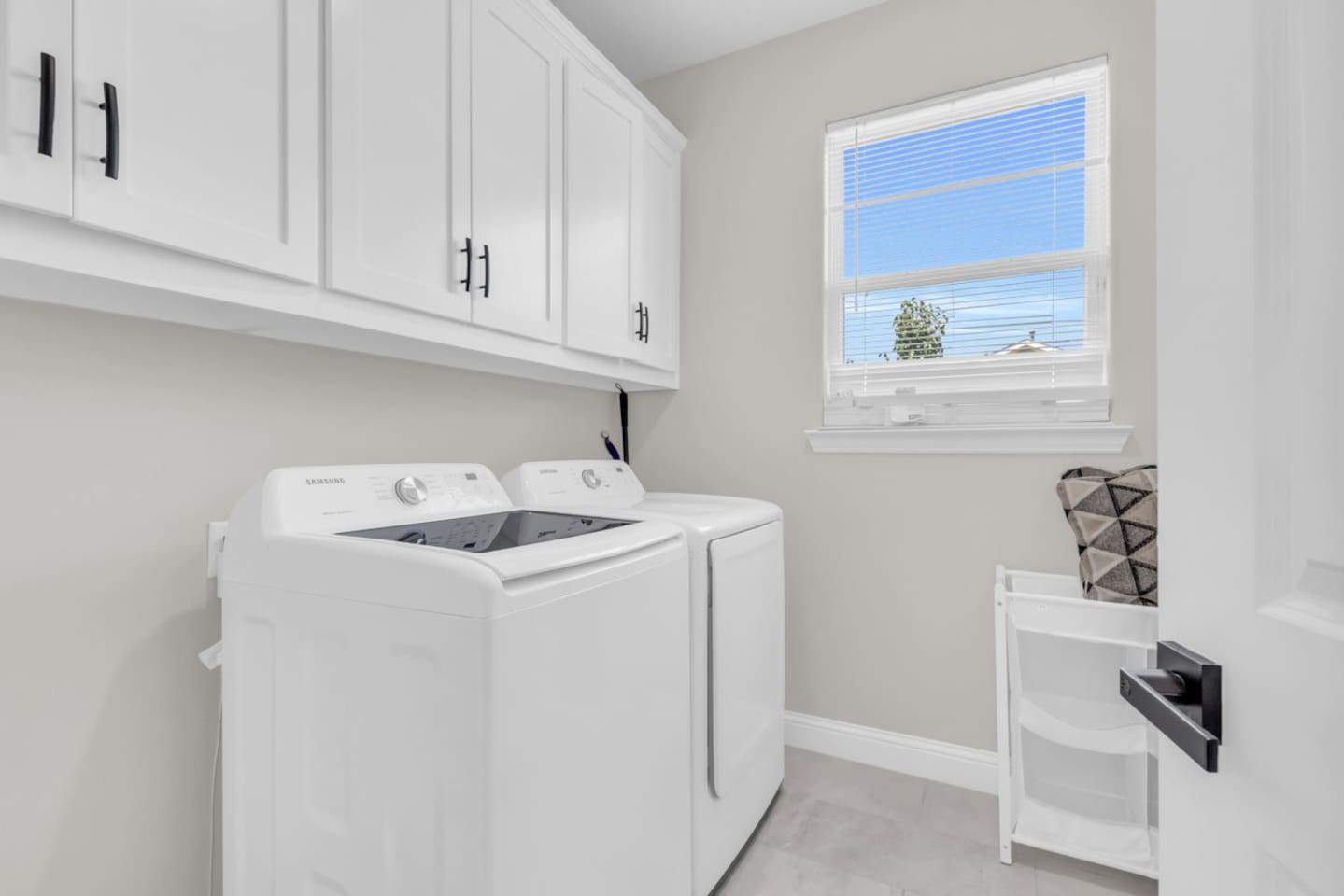 Convenient laundry room with modern washer and dryer.