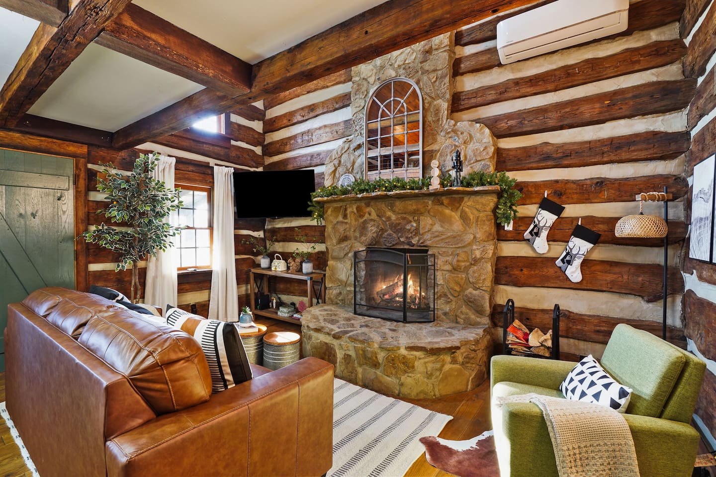 Sink into comfort by the living room fireplace - a perfect spot to unwind after a day of adventure in Hocking Hills
