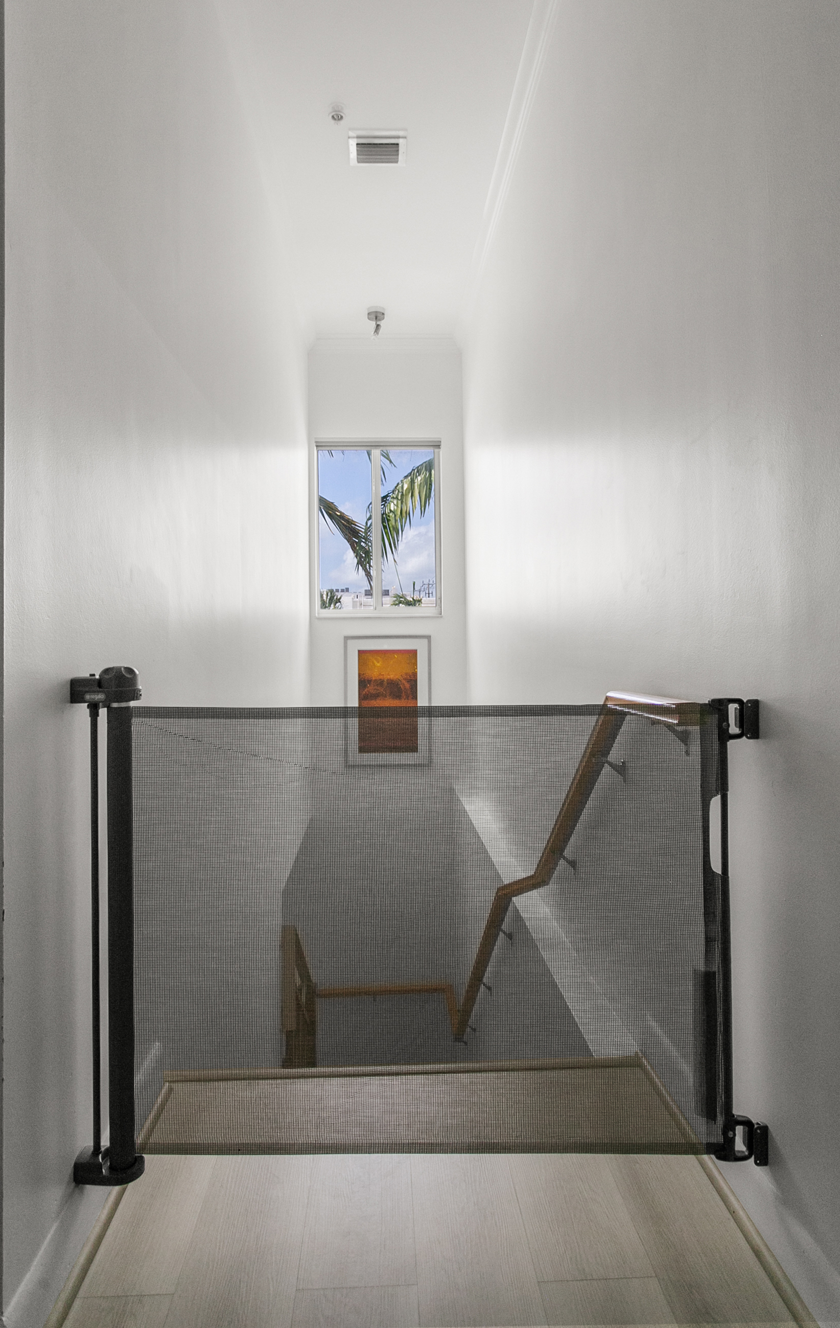 Retractable safety gate at stair landing