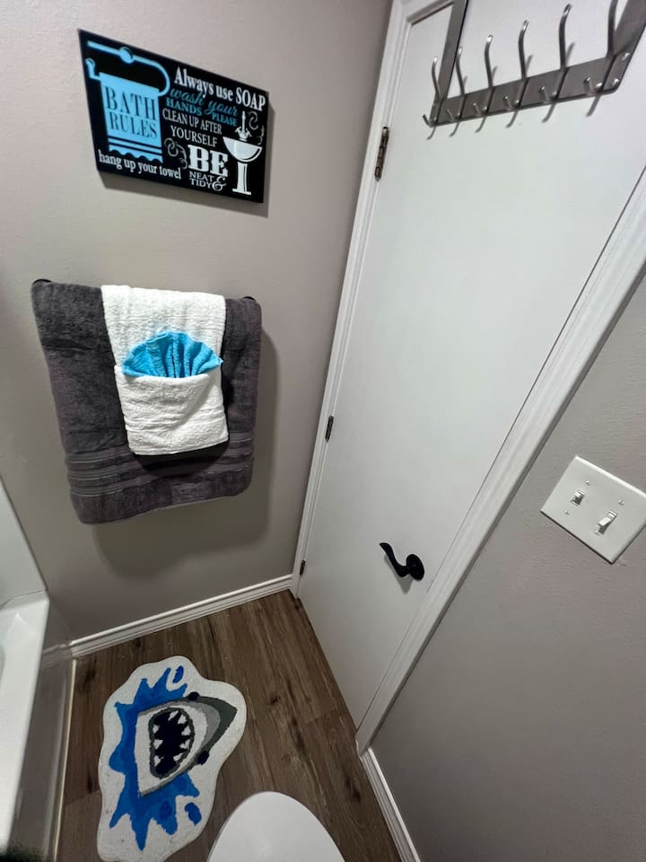 Bathroom detail with fresh towels, wall hooks, and a few simple guest touches.
