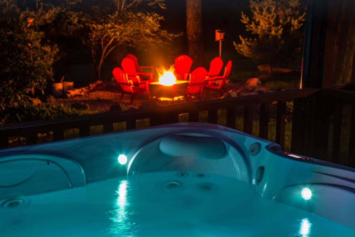 Beautiful outdoor setting equipped with 7-person hot tub and large fire pit area.