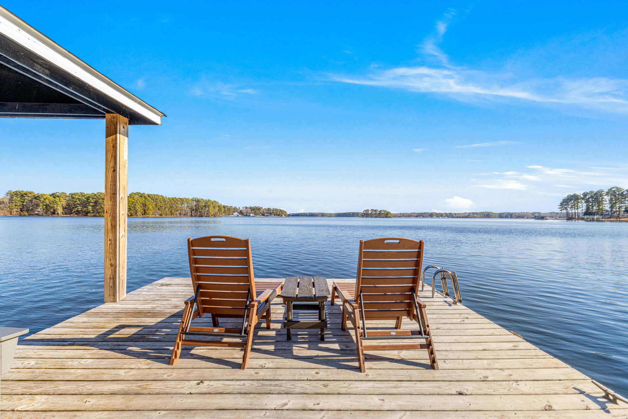 Lakeside Retreat: Unwind in stylish lounge chairs with breathtaking water views!