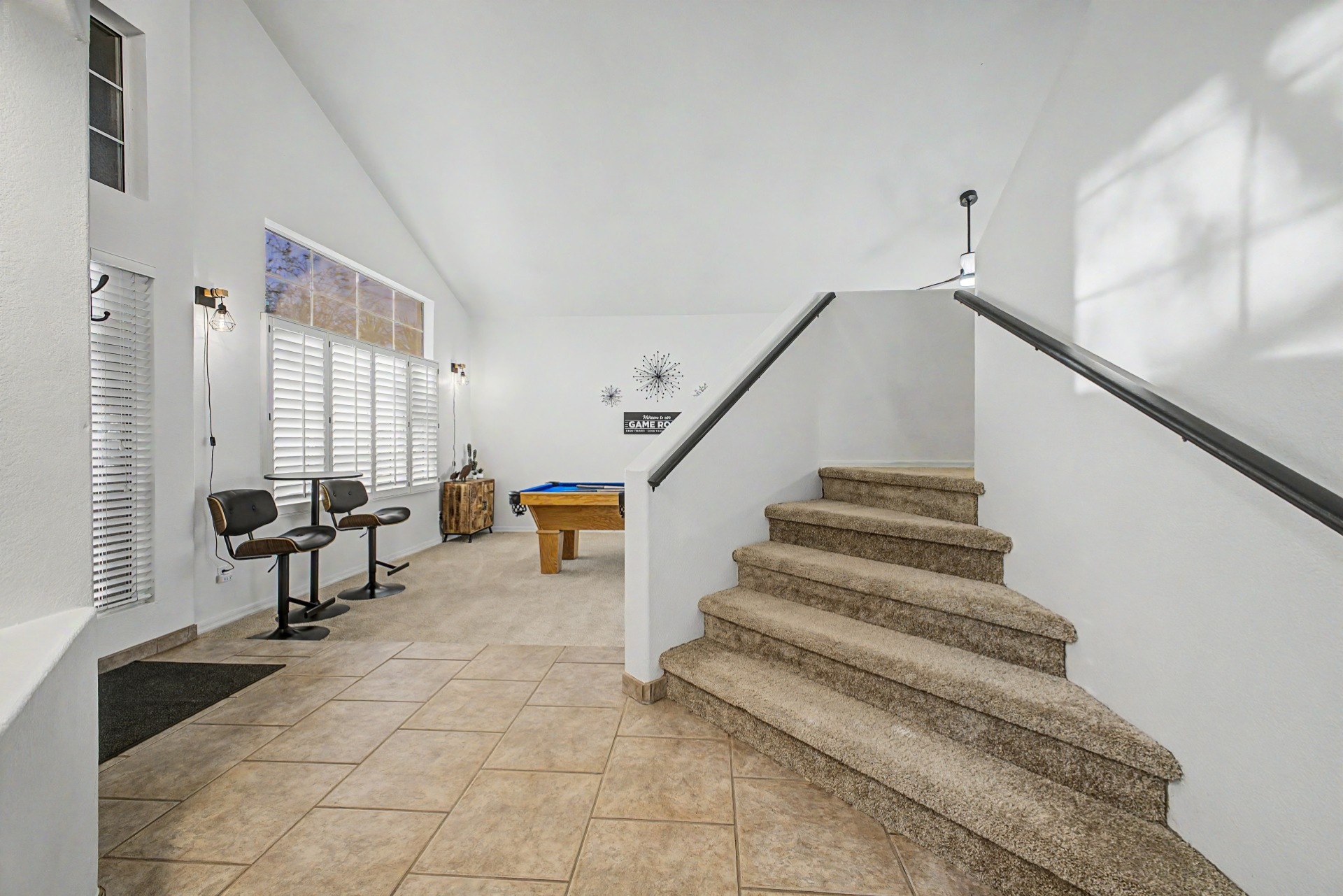 Game Room: Play, relax, and unwind in this sunlit space with a pool table, board games and stylish seating!