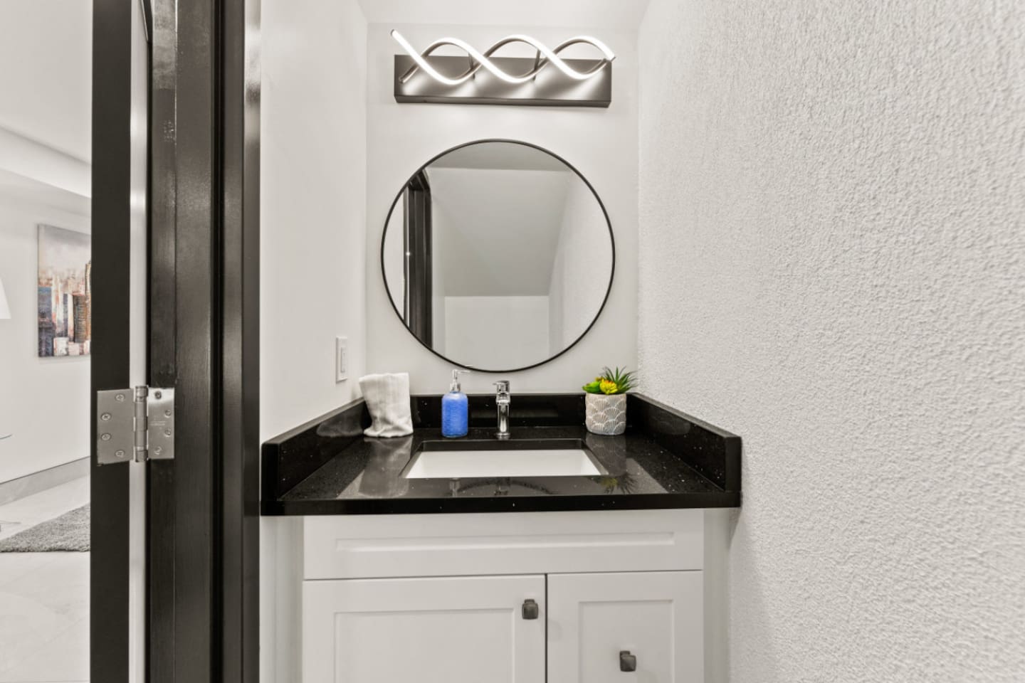 1st floor half bathroom offers modern sophistication along with convenience.