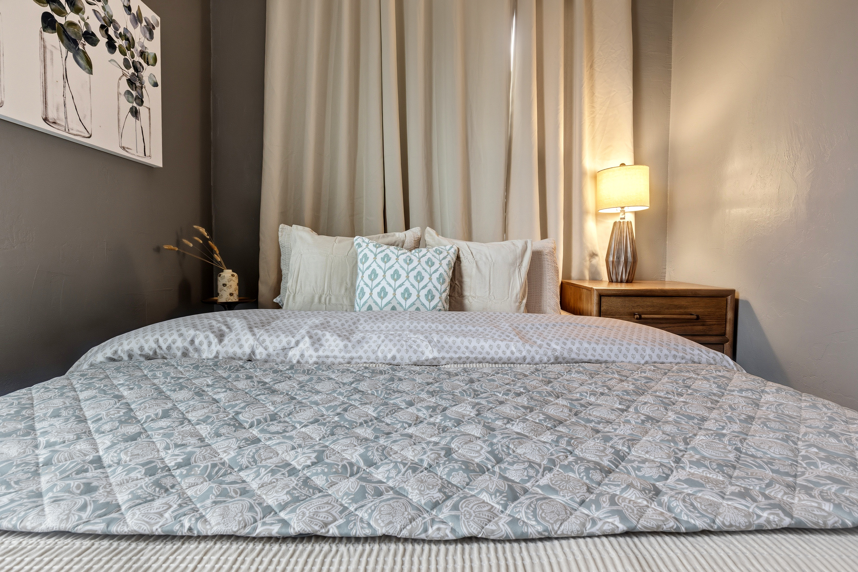 Crisp linens and layered bedding on the queen bed with a memory-foam mattress for a restful night's sleep