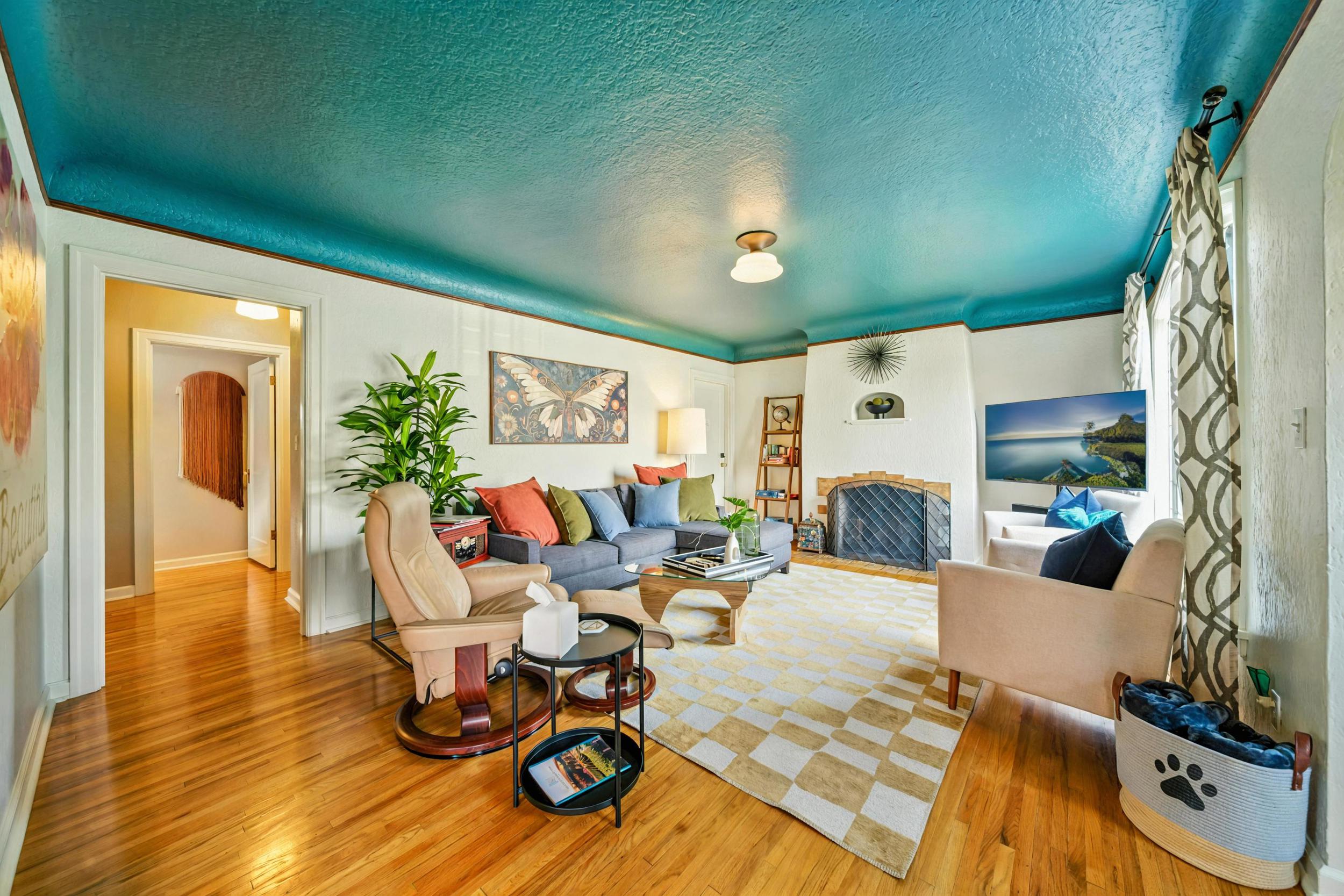 Living room with wood burning fireplace, Smart TV, record player, books & games