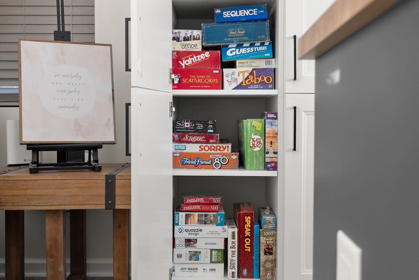 A variety of board games are available in the kitchen cabinet—perfect for family fun or cozy game nights.
