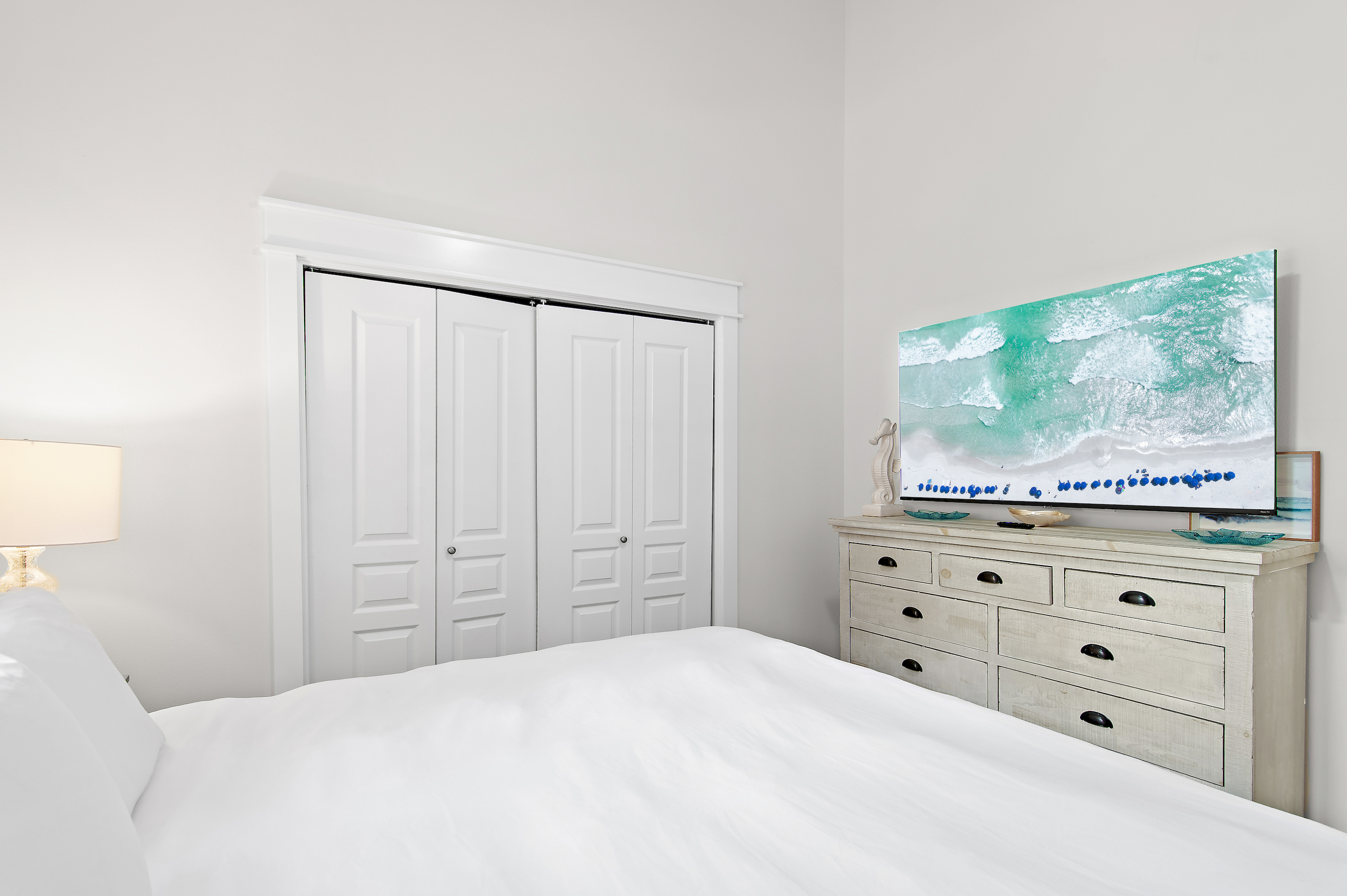 Bright bedroom with ample storage and TV