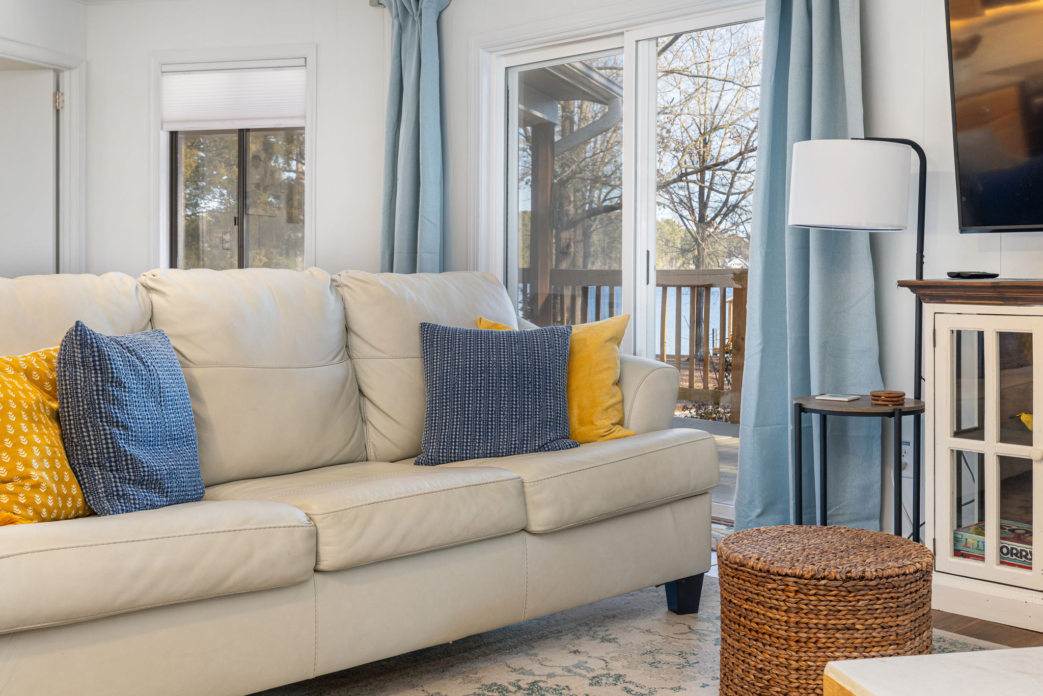 Living Room Retreat: Bright open space with lake views, inviting decor, and plush seating awaits!