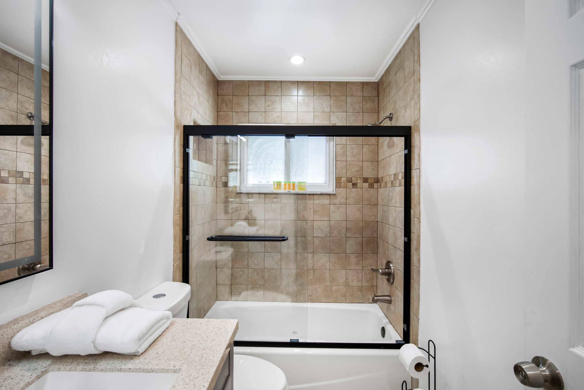 With a shower/tub combo and plenty of counter space, this bathroom works perfectly for families or groups.