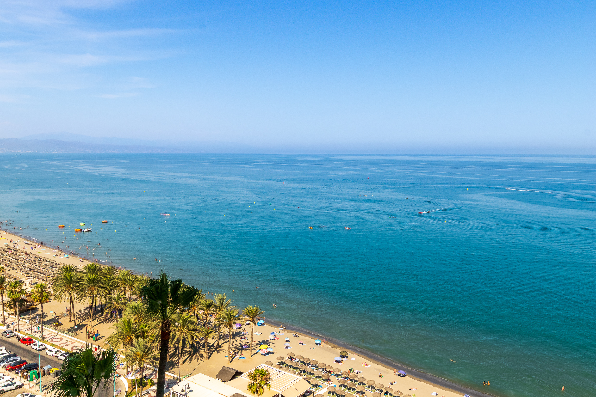 Wide open view of the Mediterranean coastline and beach.