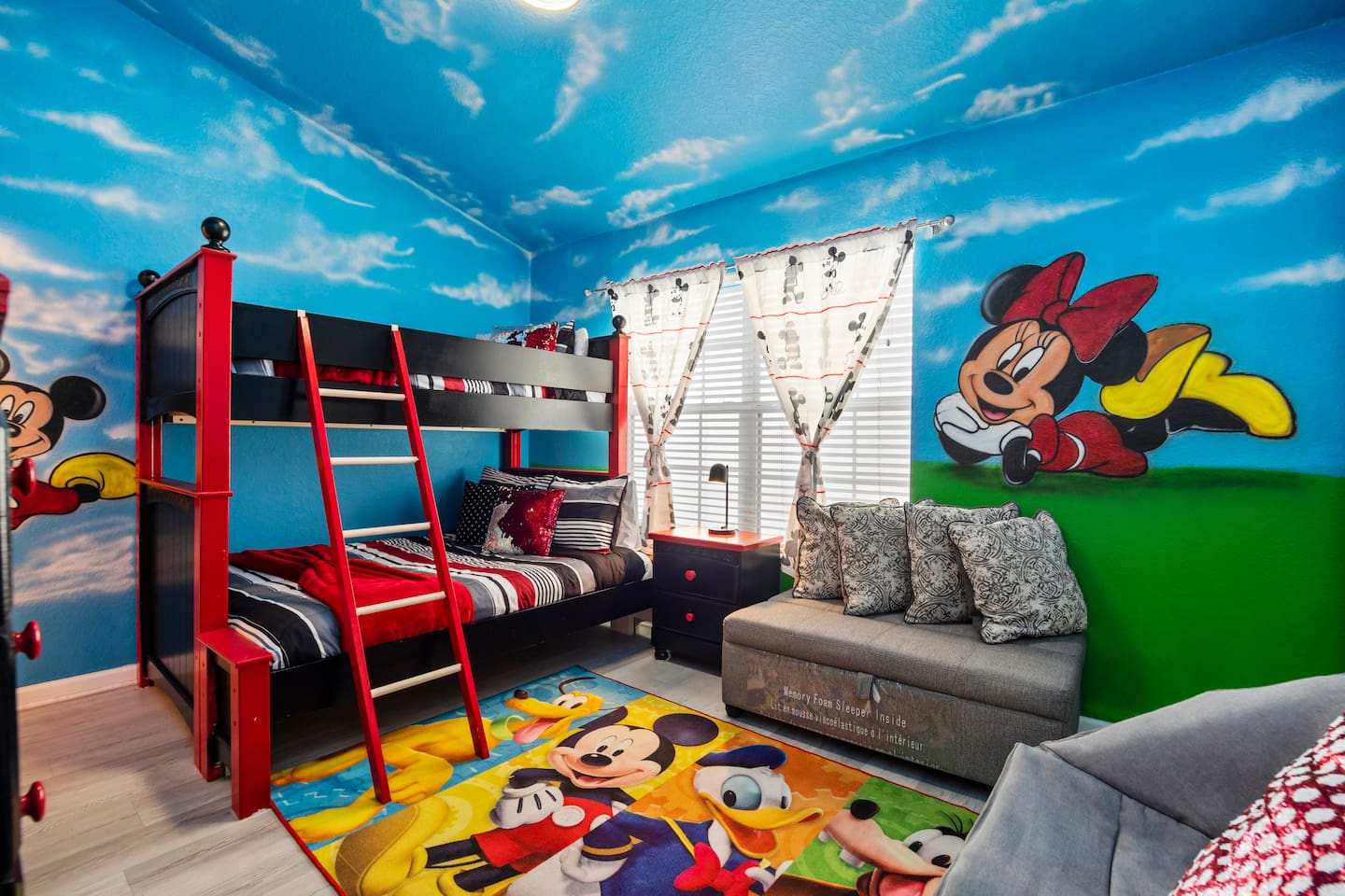 - Colorful Mickey and Minnie themed bedroom with bunk beds and cozy sofa seating  
- Bright blue sky mural walls and playful Disney accents create a magical space  
- Perfect for kids to relax, play, and dream after exciting park adventures