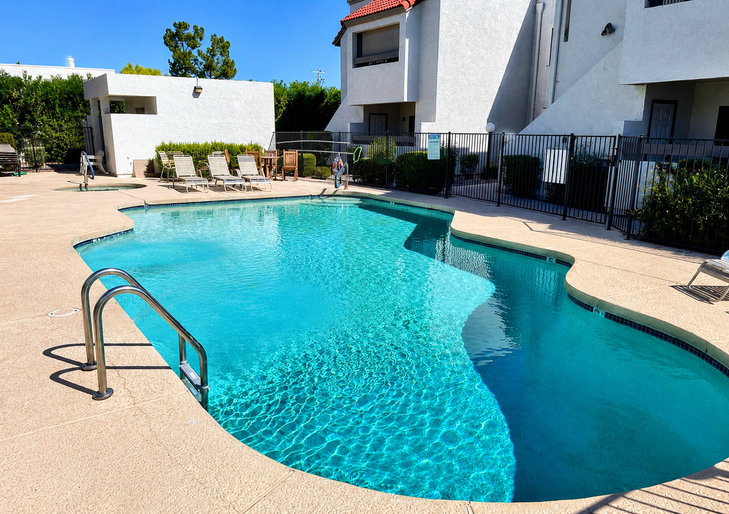 Shared community pool with lounge chairs and space to cool off outside.
