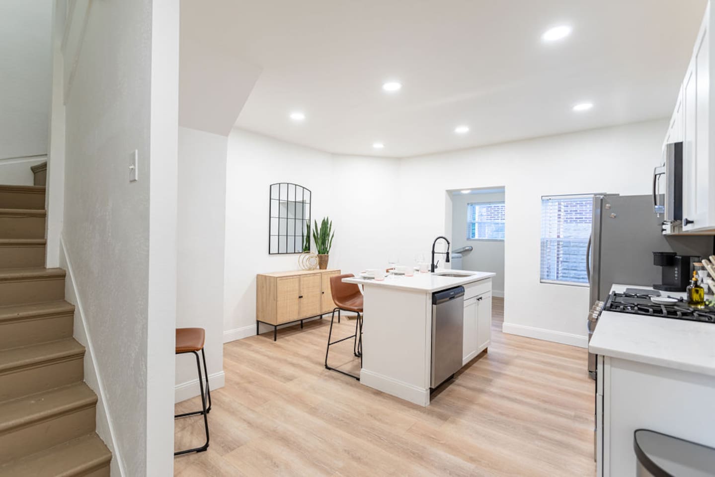 Spacious, minimalist full kitchen with clean lines and modern appliances, designed for a seamless cooking experience.