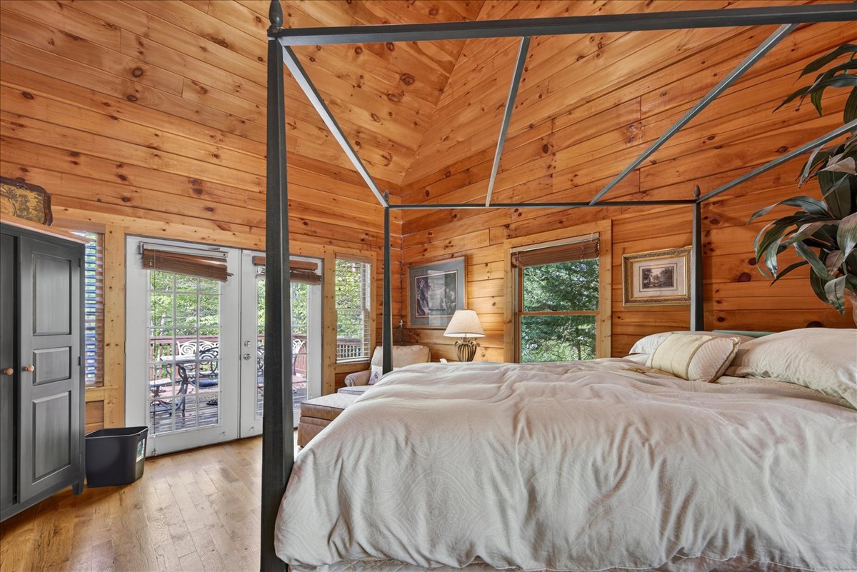 Cozy cabin bedroom with warm wood tones and rustic charm.