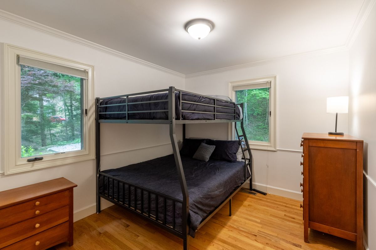 Bunk Room: Enjoy a fun night’s sleep in this spacious room with forest views and modern charm!

