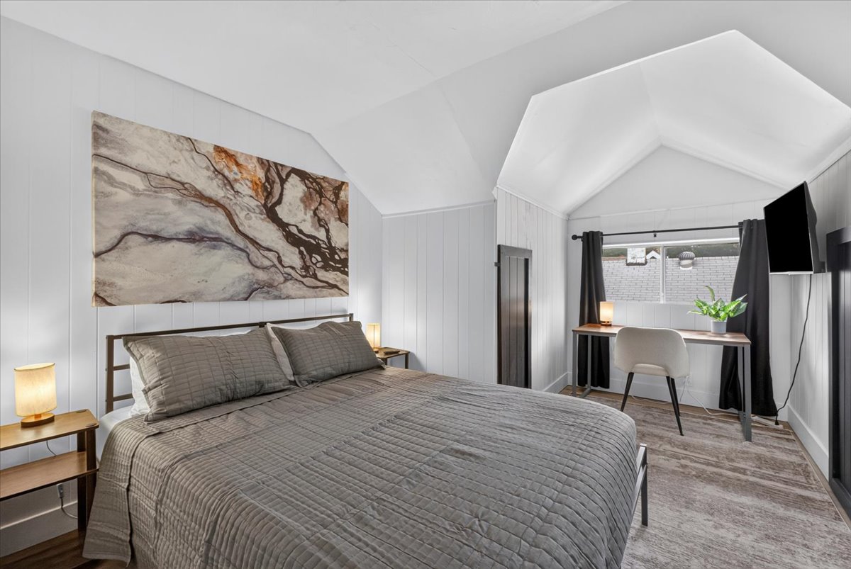 Second bedroom with a king bed and a dedicated workspace.
