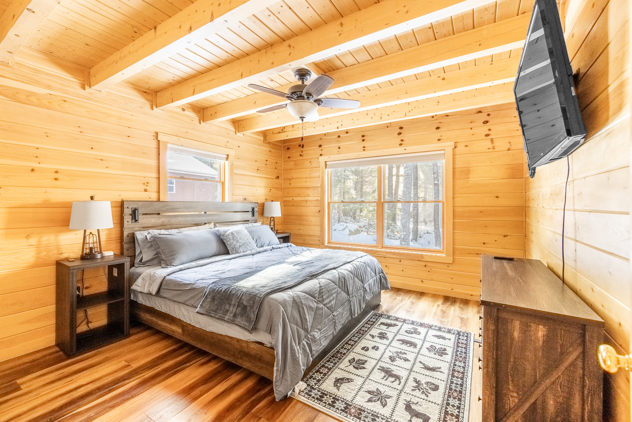1st bedroom with attached 1/2 bath, Roku TV, closet, dresser