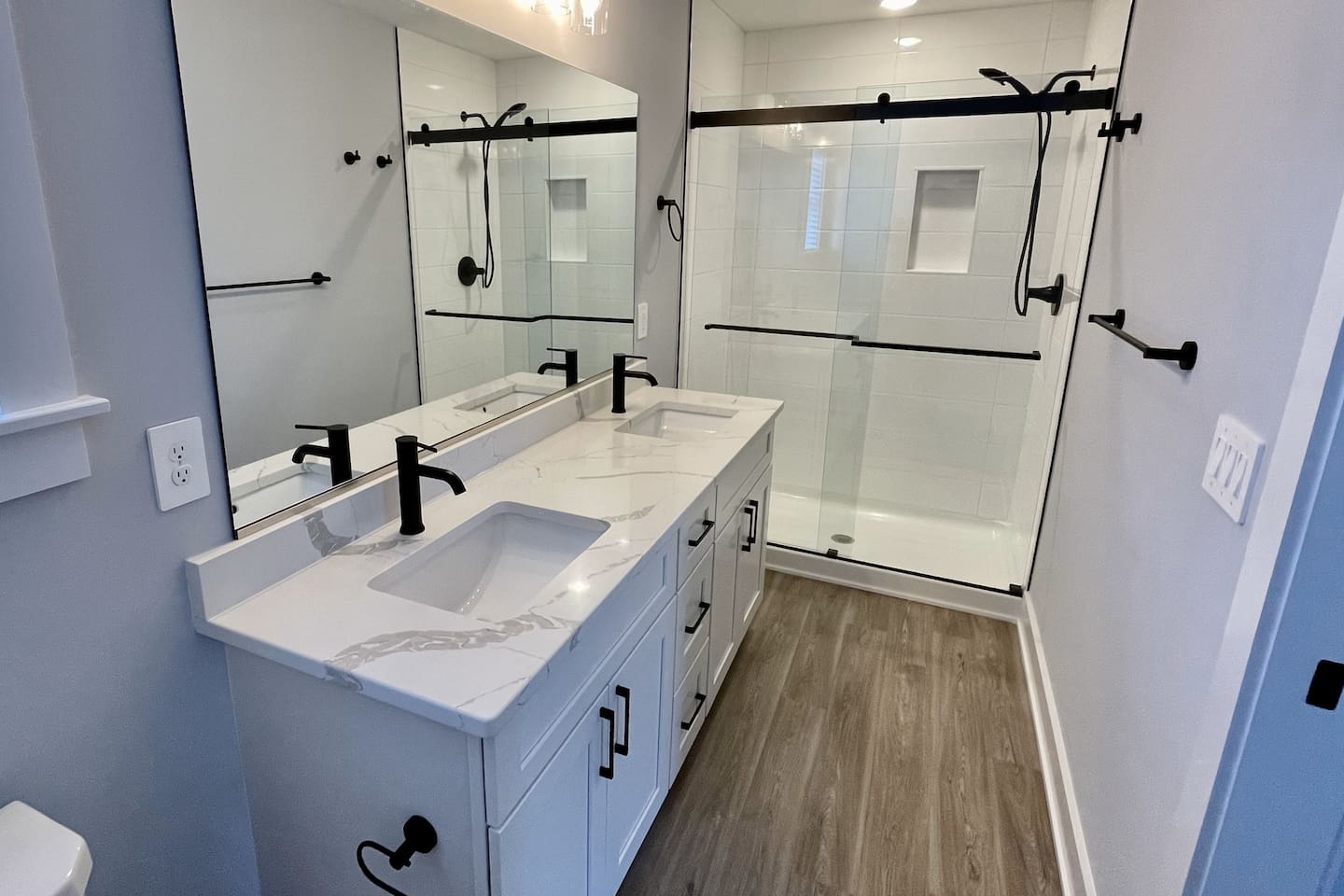 Private ensuite bathroom with double vanity and a sleek walk-in shower