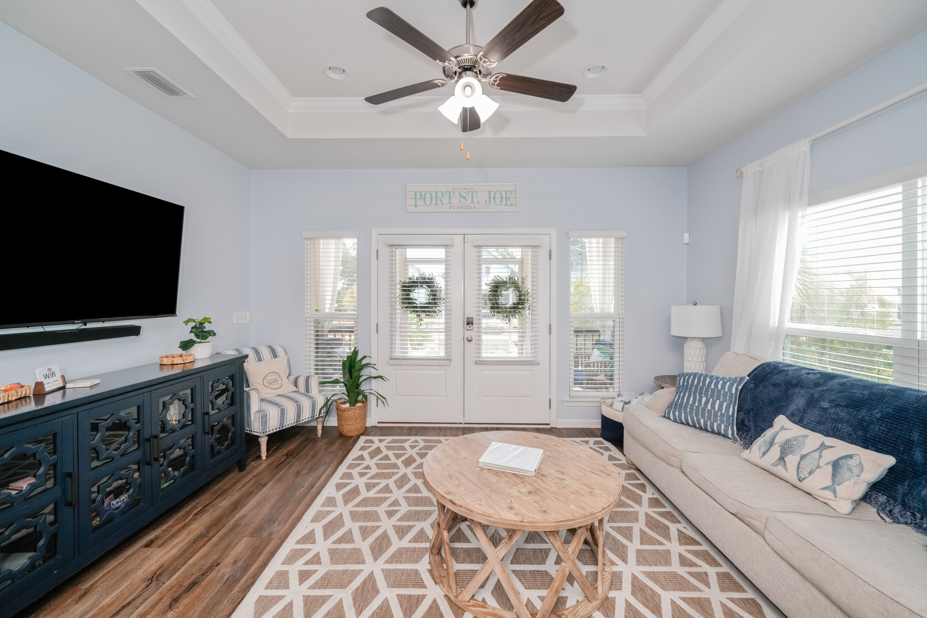 Unwind after a day at the beach in this bright, welcoming living room featuring plush seating, Smart TV, and plenty of space for family movie nights or relaxing together.