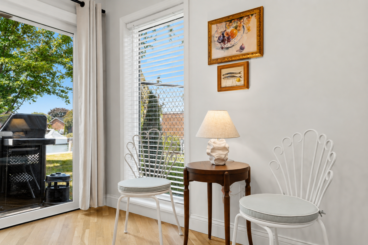 Bright sitting nook with natural light, cozy seating, and peaceful outdoor views perfect for relaxing or reading.