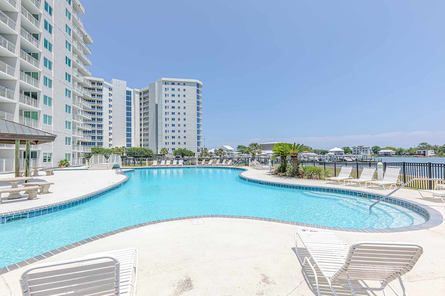 Poolside Paradise: Dive into relaxation by the shimmering pool with stunning waterway views!