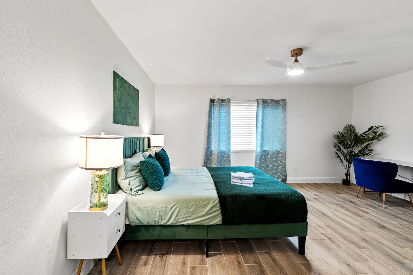 Relax in the stylish primary bedroom with vaulted ceilings and natural light.