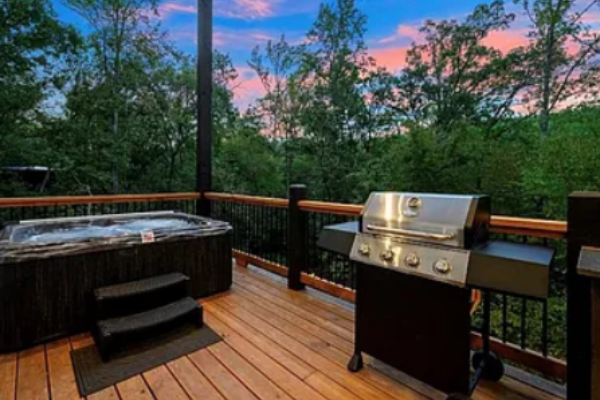 Private deck featuring a hot tub and grill for ultimate outdoor enjoyment