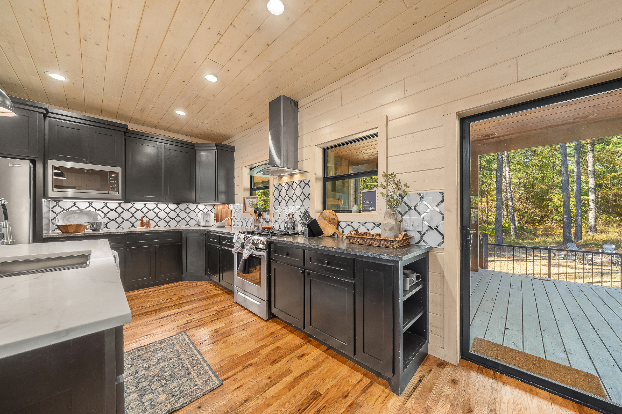 Chef inspired kitchen with gas range, generous counter space, and a convenient walkout to the outdoor grill and deck.