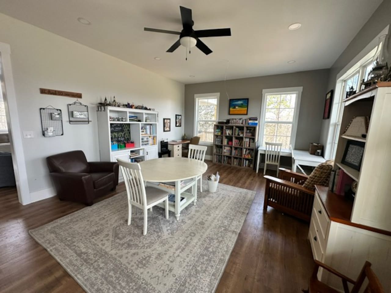 Our library features three work spaces, two comfy chairs for reading, PLENTY of books (we love the classics!), children's art supplies & crafts, as well as a piano and a few guitars. Beautiful views from these windows too. Open to living room/foyer.