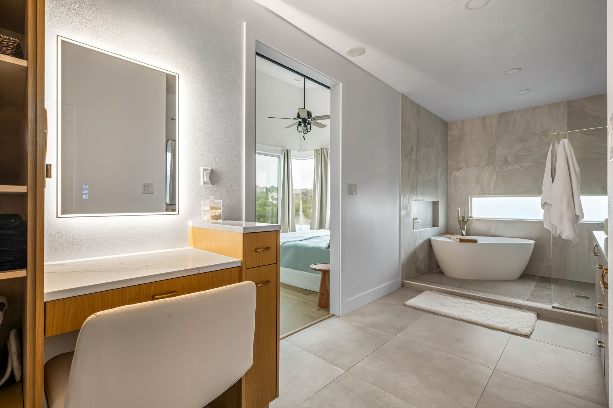 Elegant bathroom with lighted mirror and spa-style tub