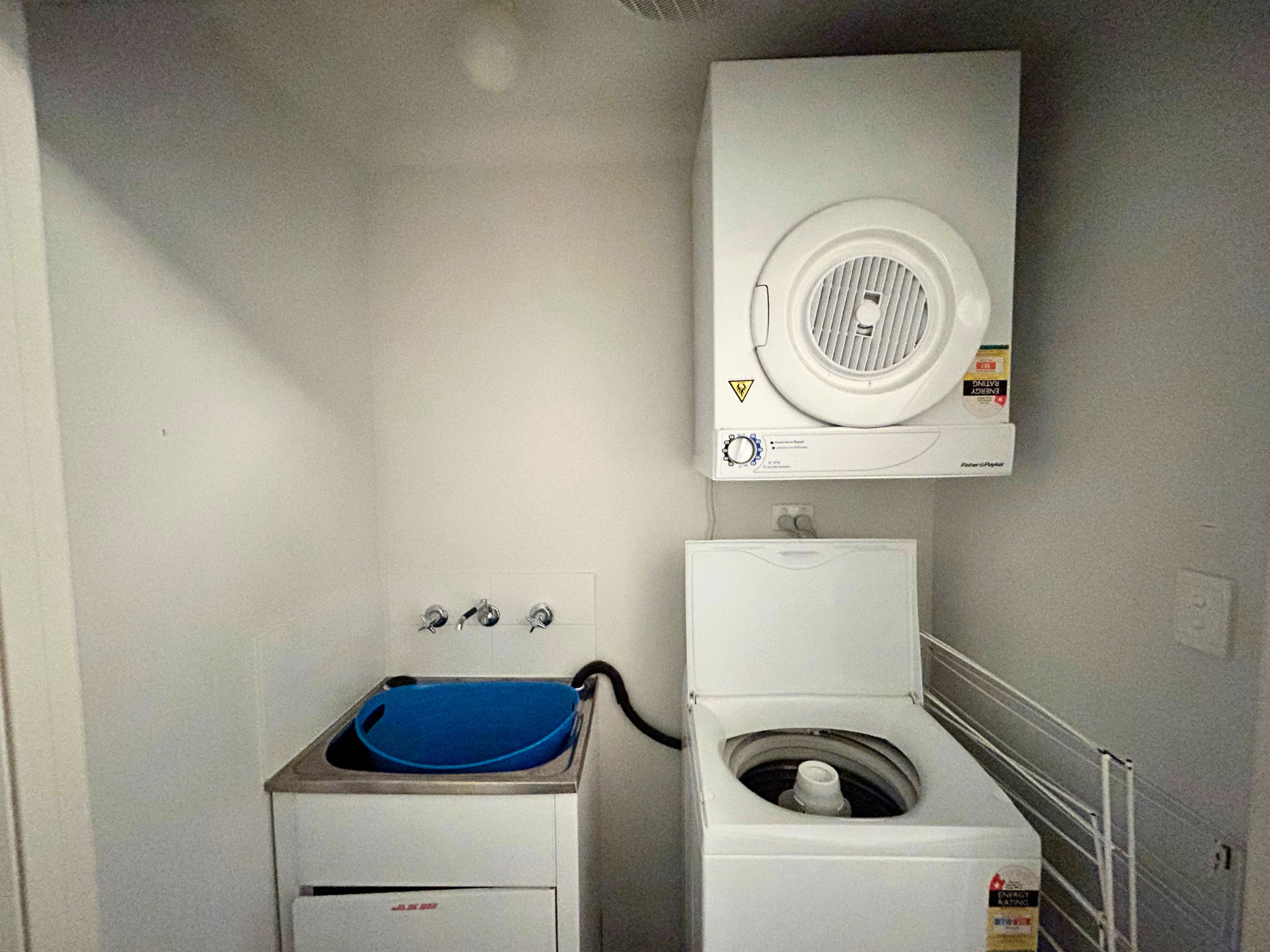 European laundry with top load washer & clothes dryer