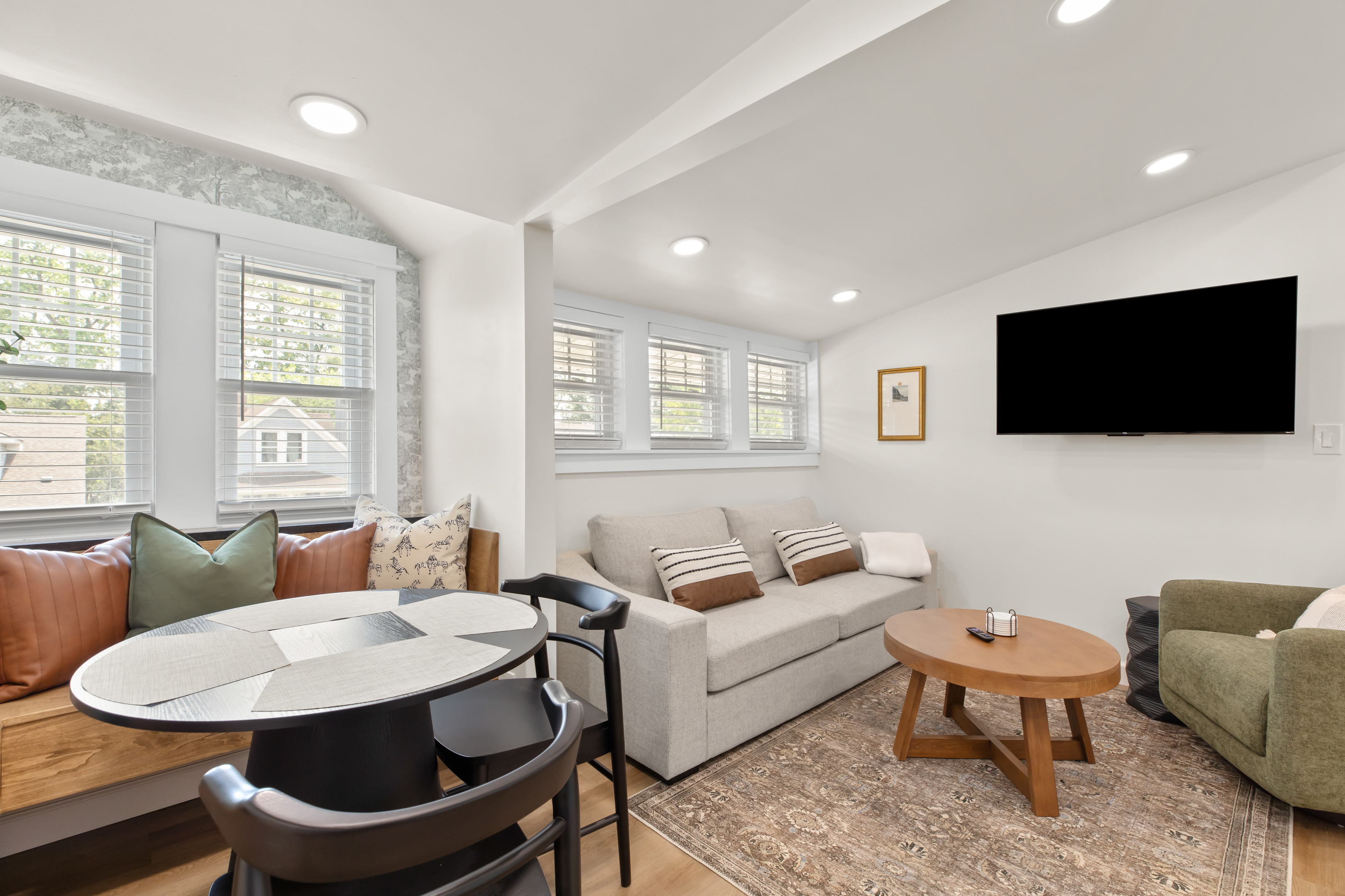 Cozy and inviting living area with a smart TV, plush seating, and plenty of natural light—perfect for relaxing after a day out.