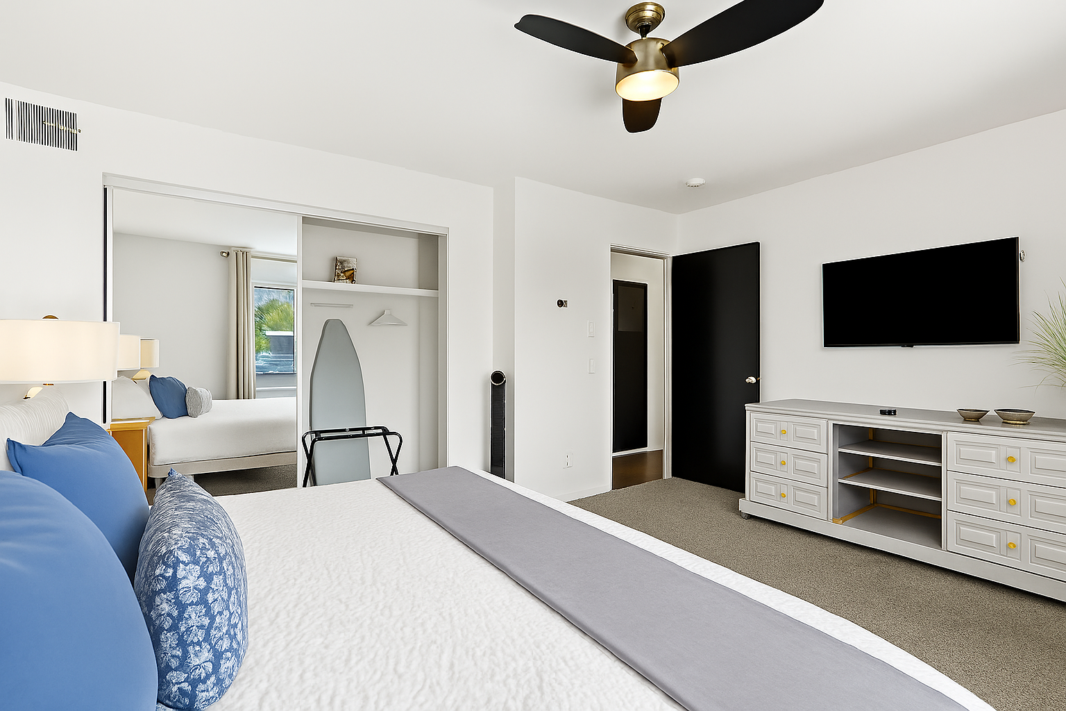 Enjoy a peaceful stay in a thoughtfully designed space with a king bed and modern wood wall feature.