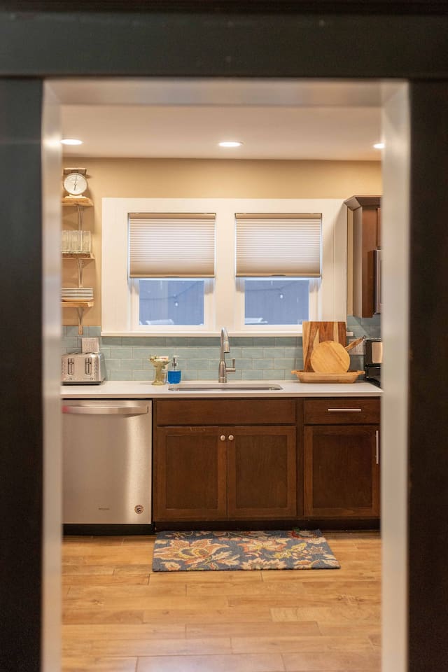 Thoughtfully designed for the home chef, this hallway opens into a modern kitchen featuring quartz countertops, stainless steel appliances, and a comprehensive selection of cookware.