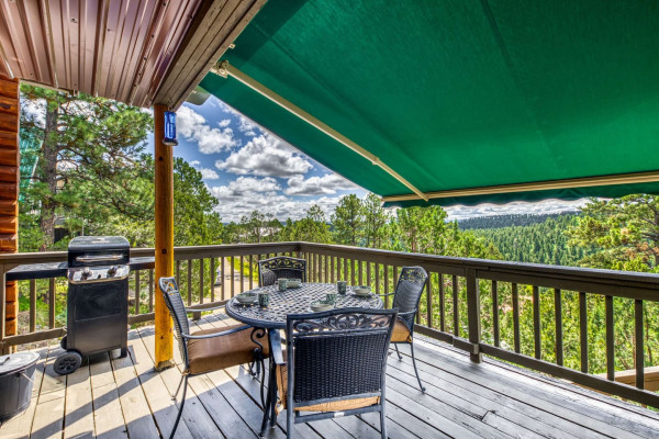 The shaded patio is your perfect retreat, featuring tables and chairs with beautiful nature views, offering comfort and tranquility.