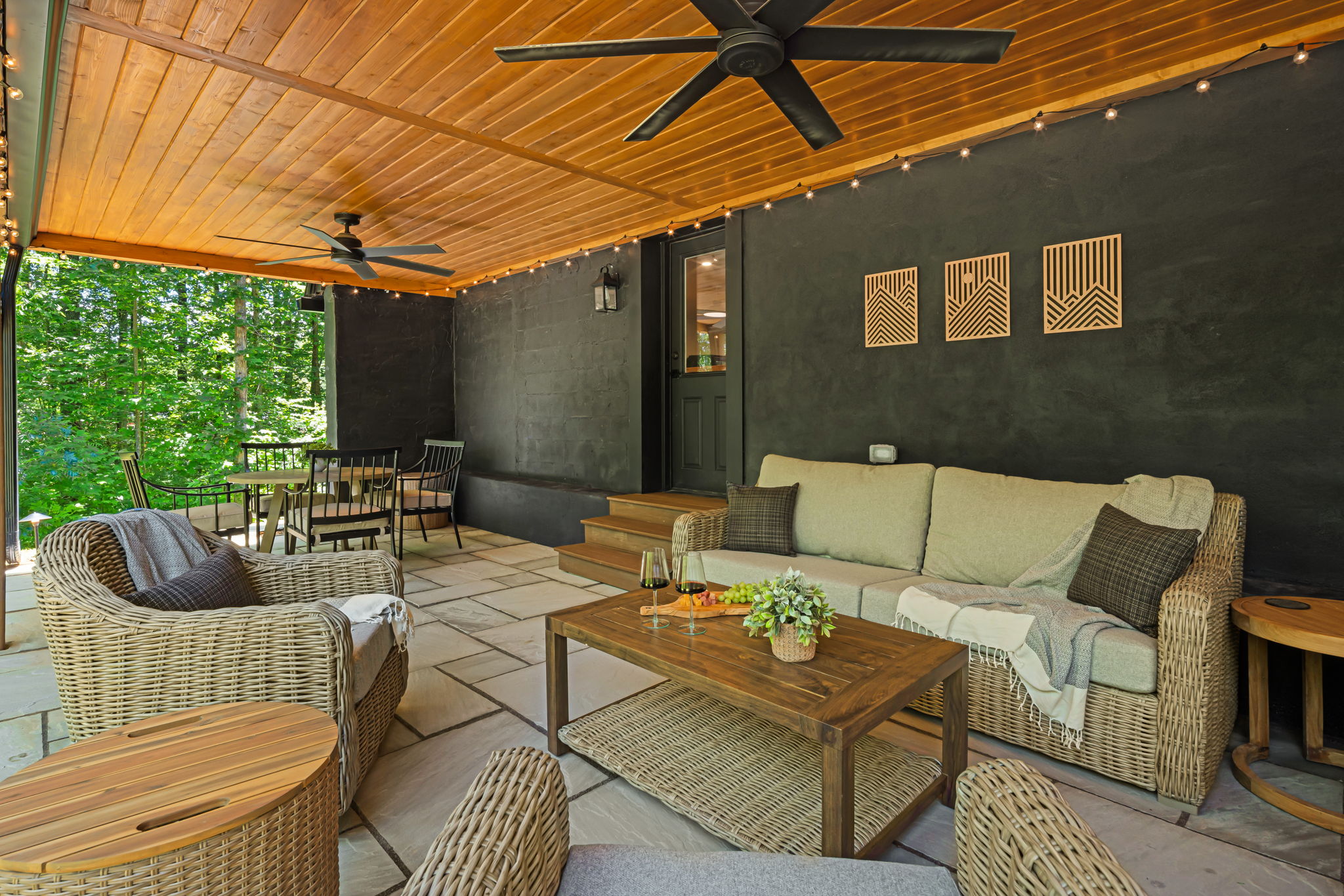 This covered patio is one of our favorite spaces with comfortable furniture for casual conversations or dining while enjoying peace in the foothills of NC Mountains.