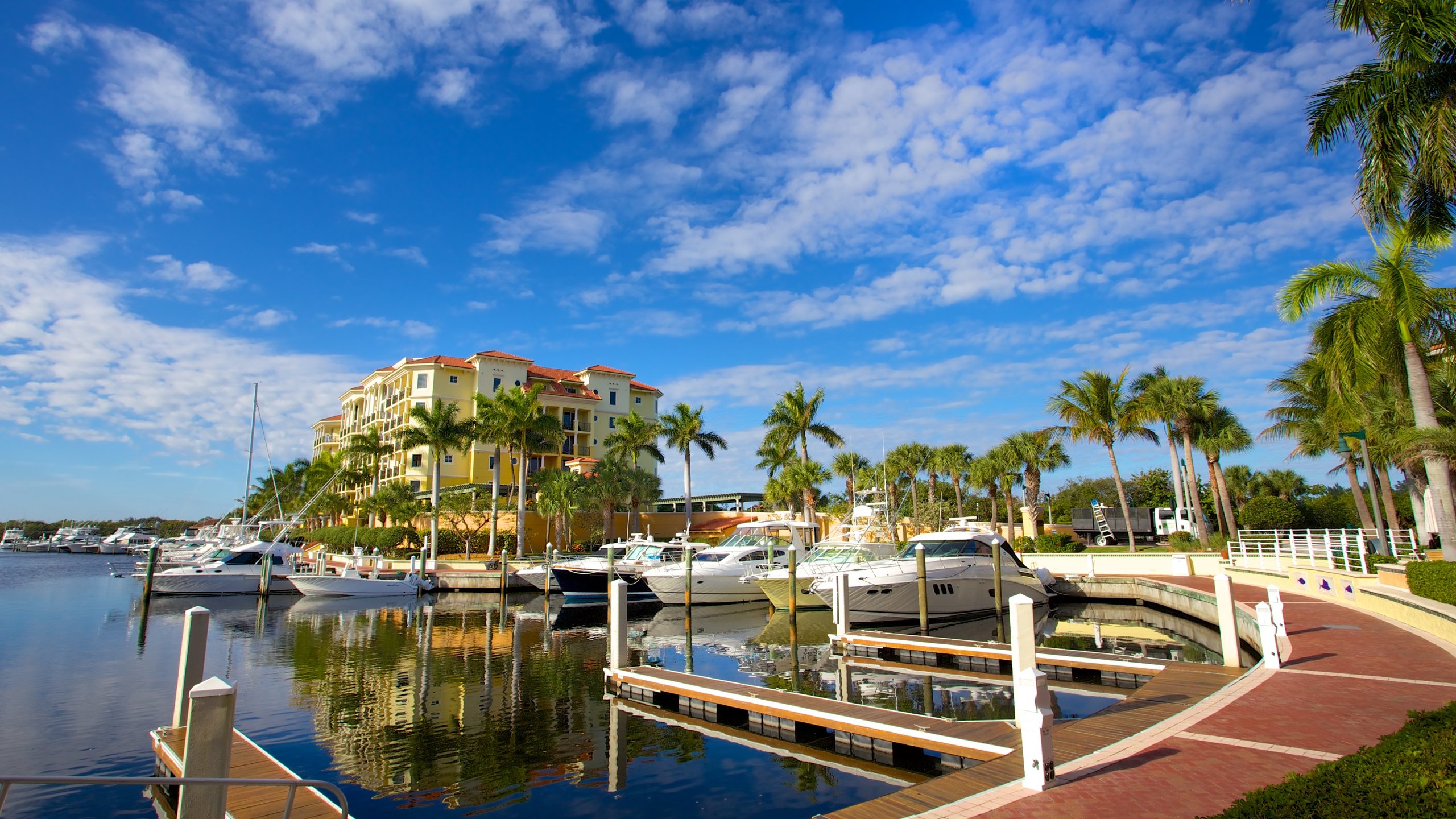 Elegant yachts and palm-lined promenades set the scene at Jupiter's exclusive Marina. A serene oasis where luxury meets coastal charm beneath endless blue skies