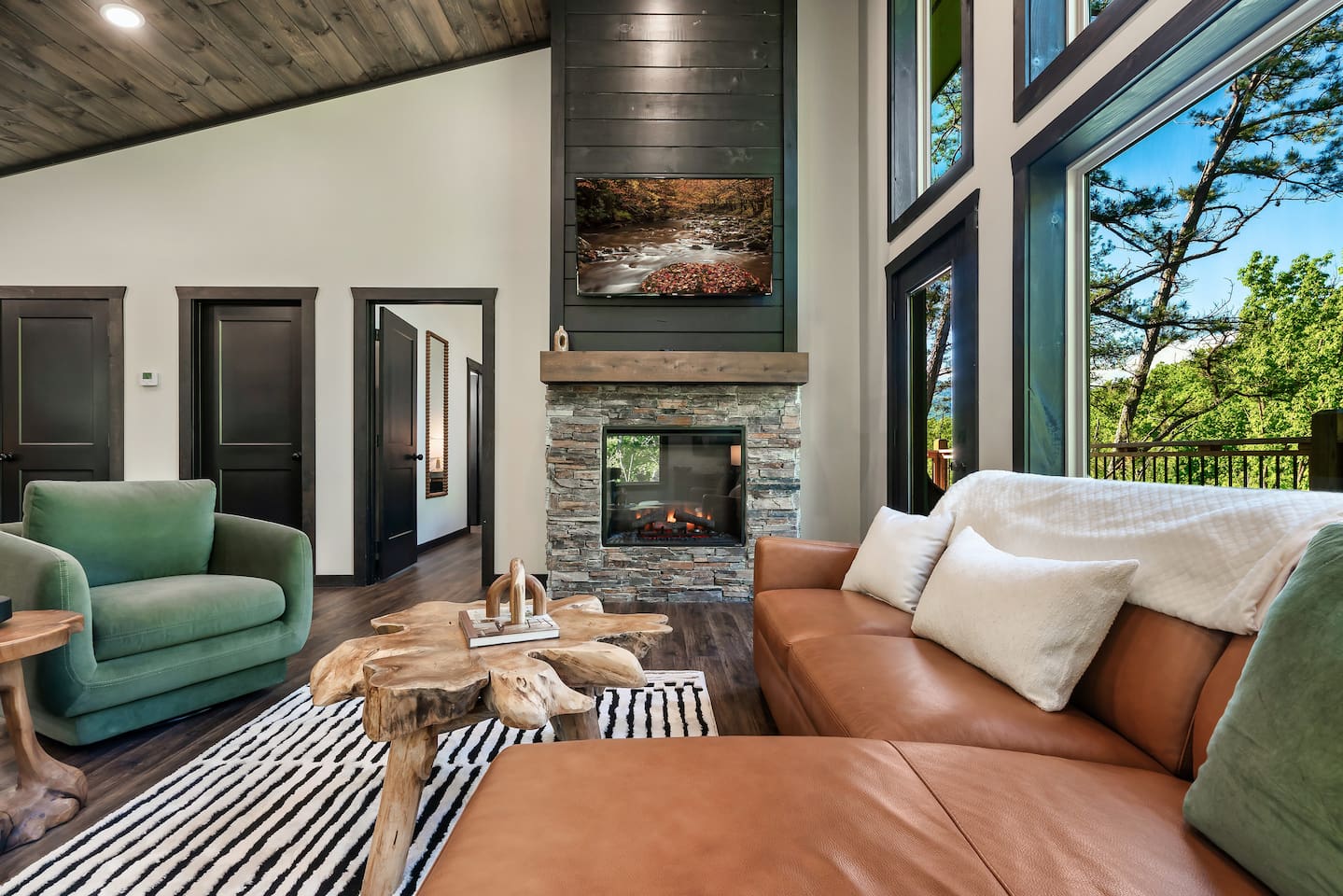 Relax by the stone fireplace in this bright, open mountain retreat.