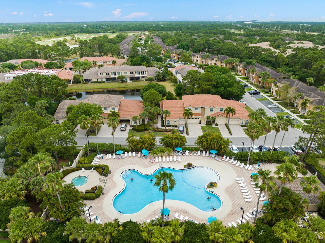 Aerial view of the community amenities featuring the pool, spa, sundeck, and beautifully maintained grounds.