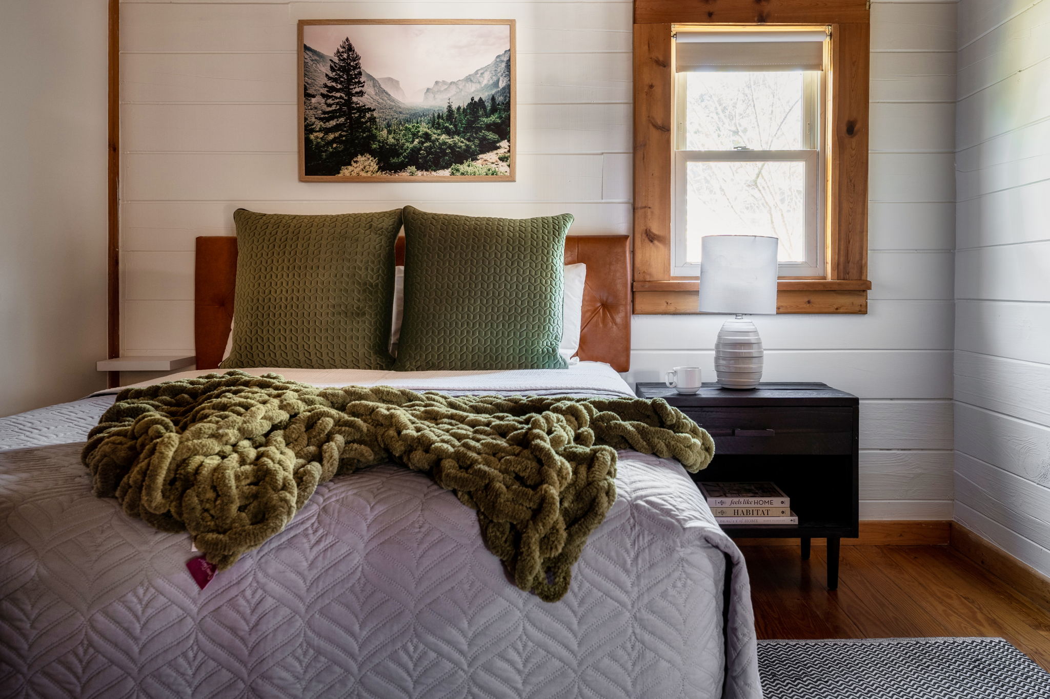 Relax in comfort in our inviting bedroom featuring a cozy queen bed, perfect for a peaceful night's sleep.