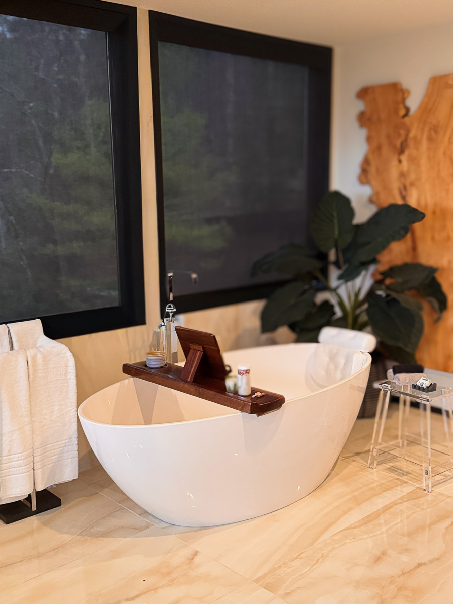 Primary Suite bath &mdash; freestanding soaking tub on the tree line