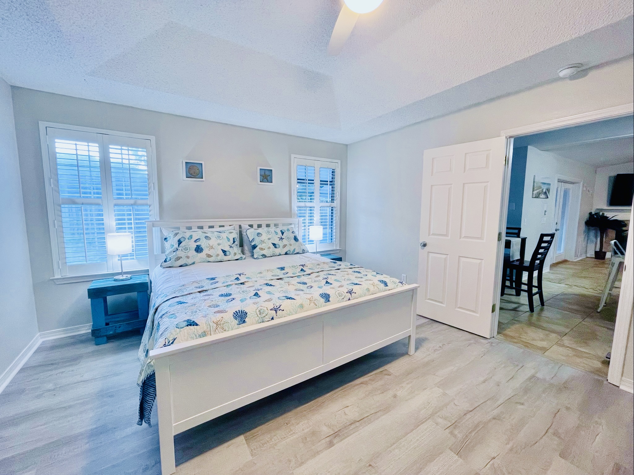Primary King bedroom featuring Dream Cloud mattress, plush linens, and view out to the lanai