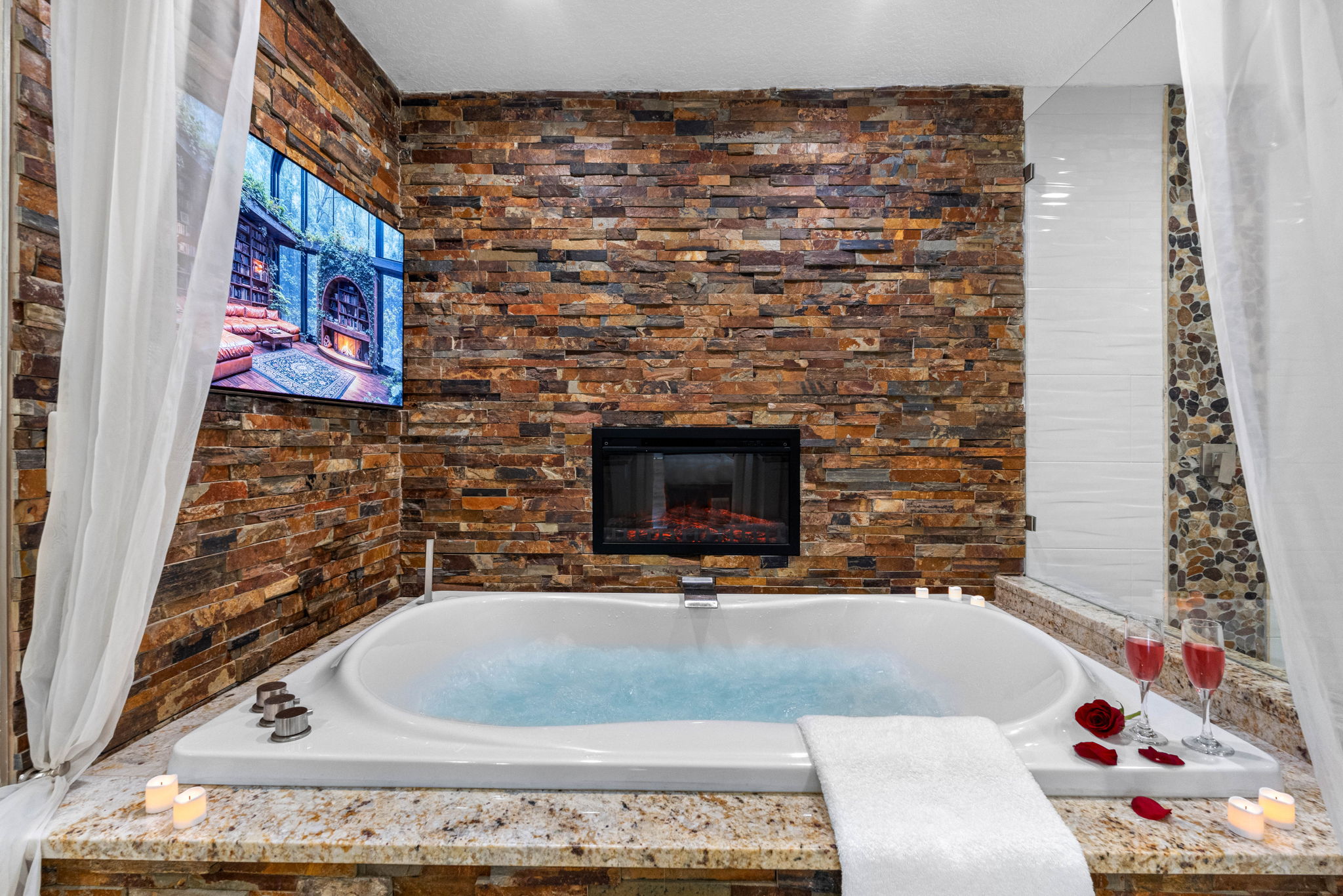 Features a deep soaking tub perfectly positioned in front of a wall-mounted TV, allowing you to unwind with your favorite show or movie as you soak away the day.