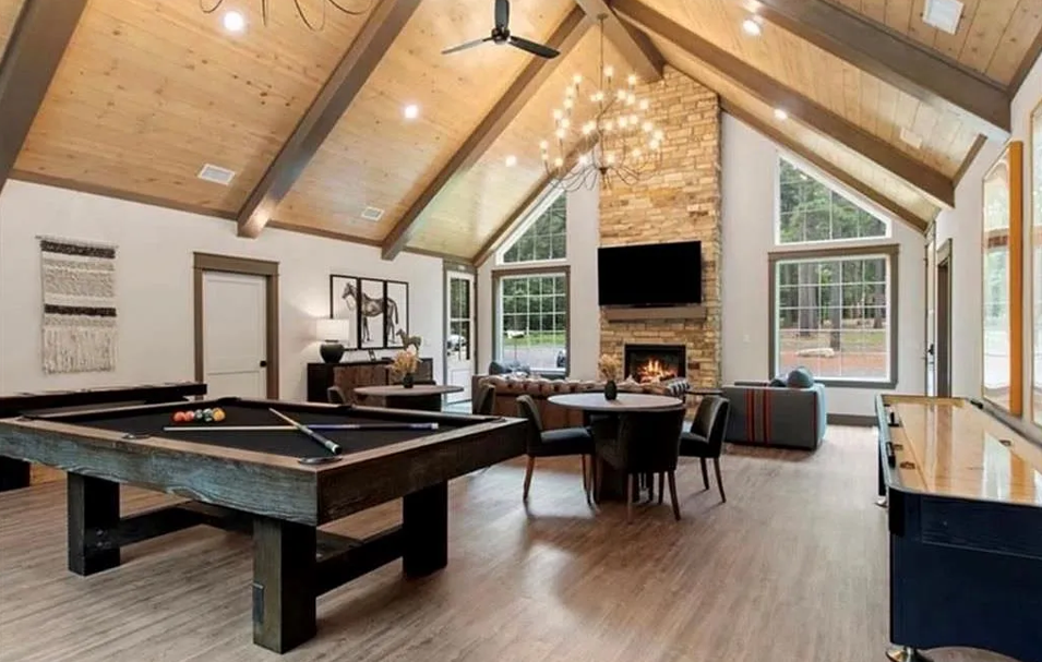Shared spacious entertainment loft with pool table, fireplace, and open-concept cabin charm