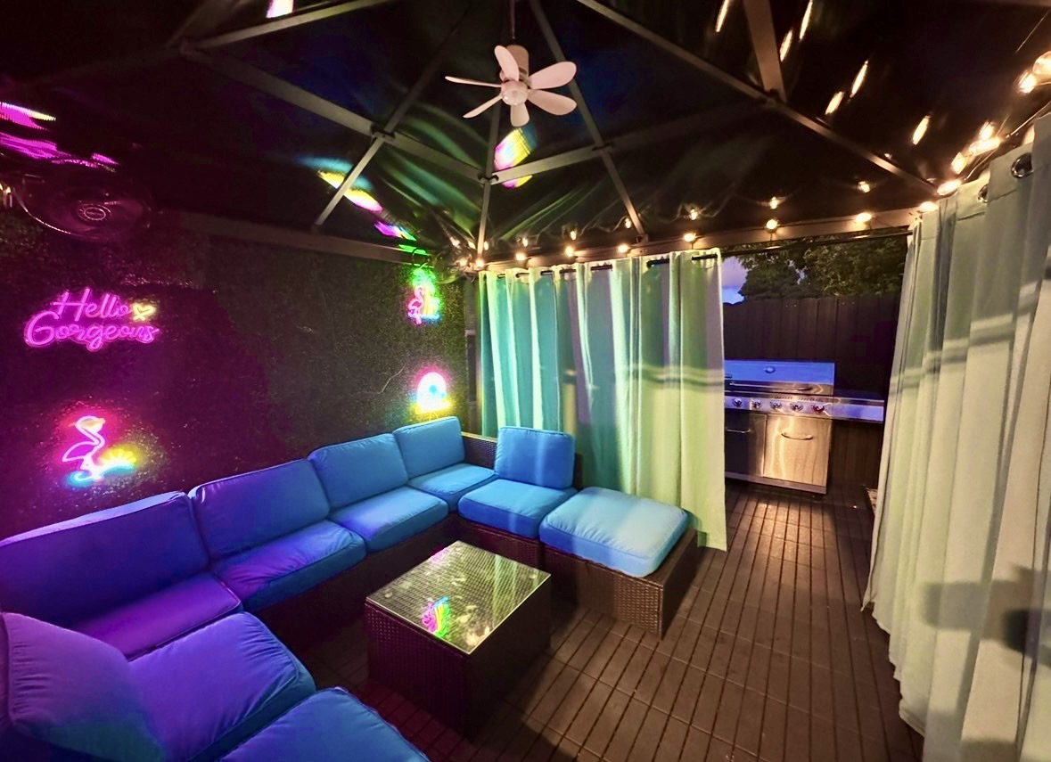 Gazebo with Outdoor Furniture next to Barbecue Grill
