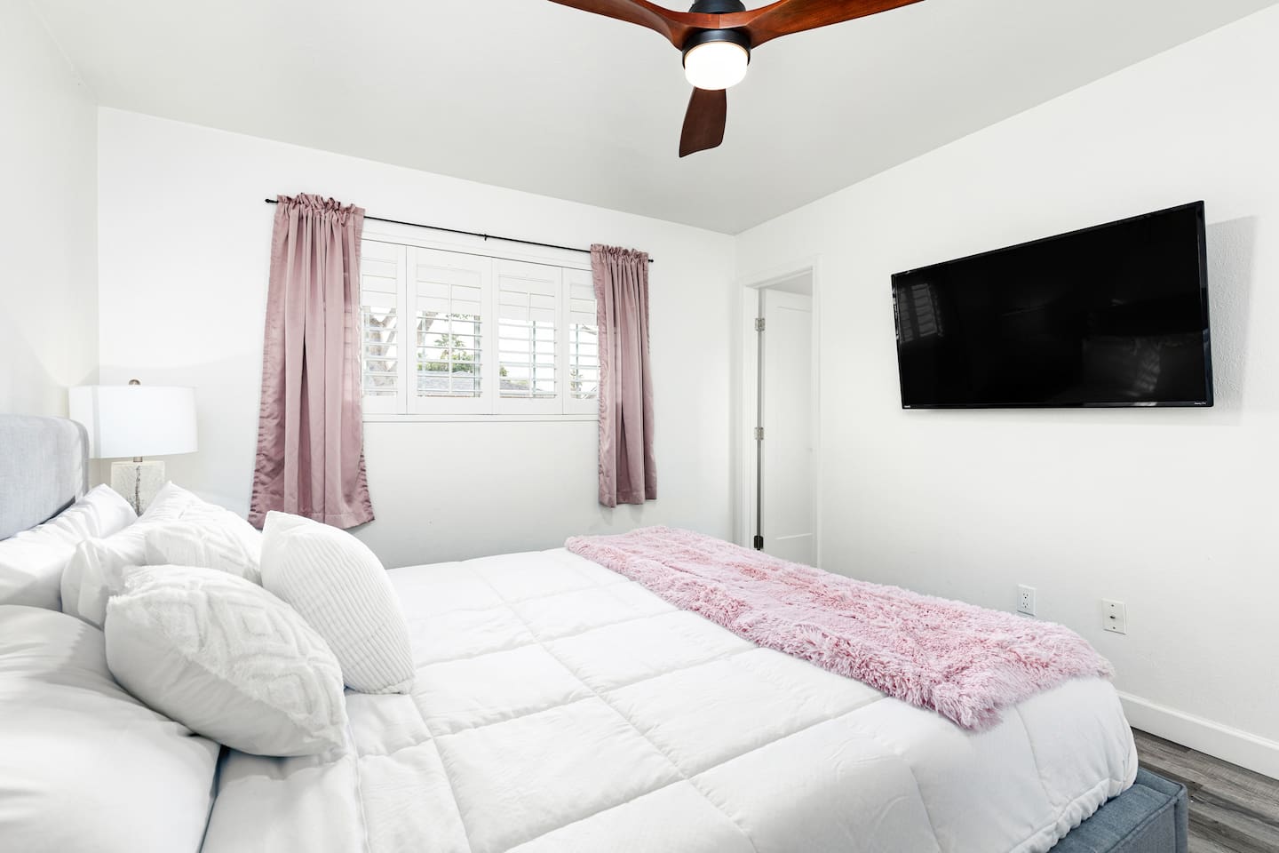 Relax with your favorite shows on the mounted Smart TV while enjoying plush bedding and calming tones throughout the room.

