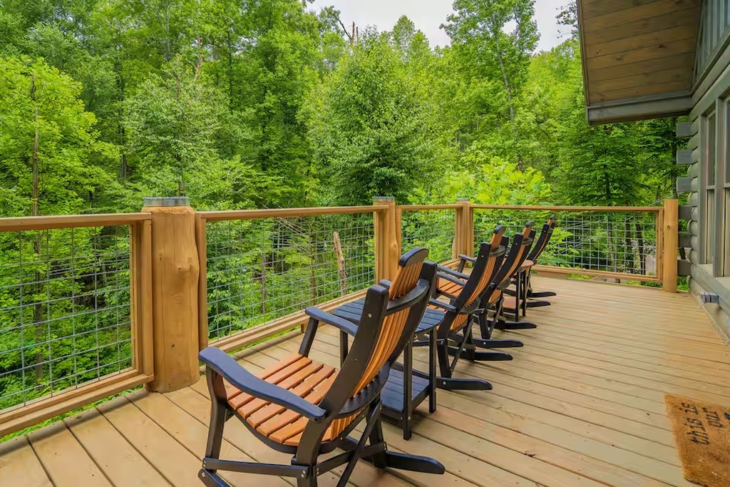 Start every morning with coffee on the deck at Bear Paws Cabin. Four Adirondack rocking chairs overlook the forest canopy